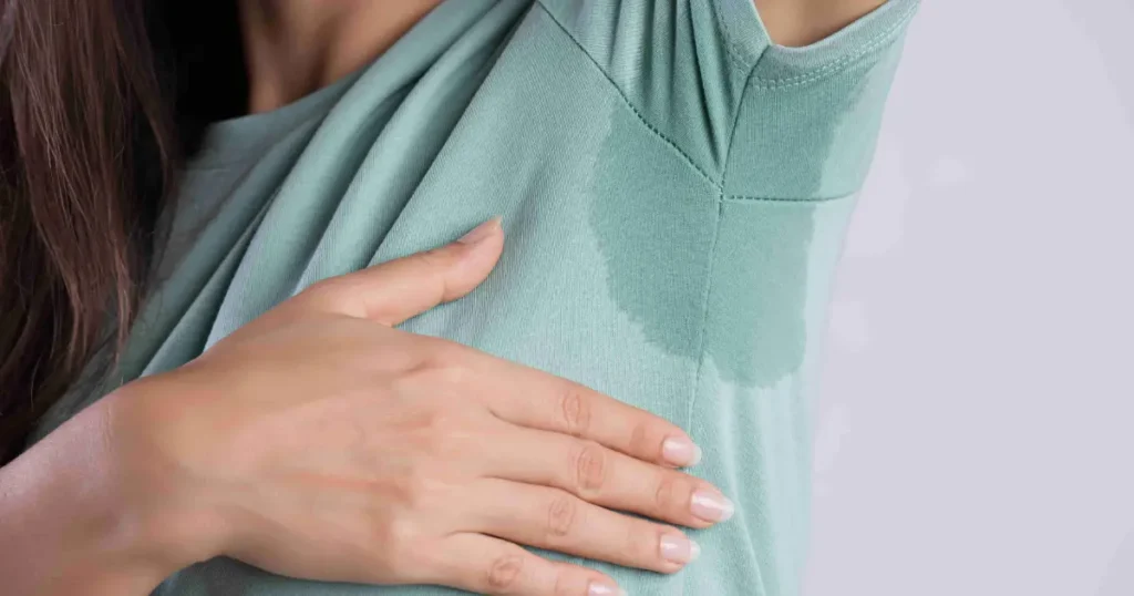 Current image: Woman showing underarm sweating, considering Botox treatment for excessive sweating in Corpus Christi, TX